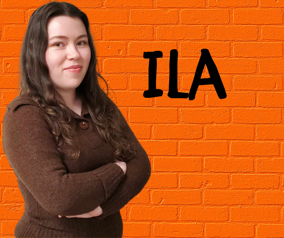 FLIC Employment Advocate Ila Rose (she, her) Finger Lakes Independence Center Employment Advocate Ila Rose (she, her) in front of a orange brick wall with first name in black letters