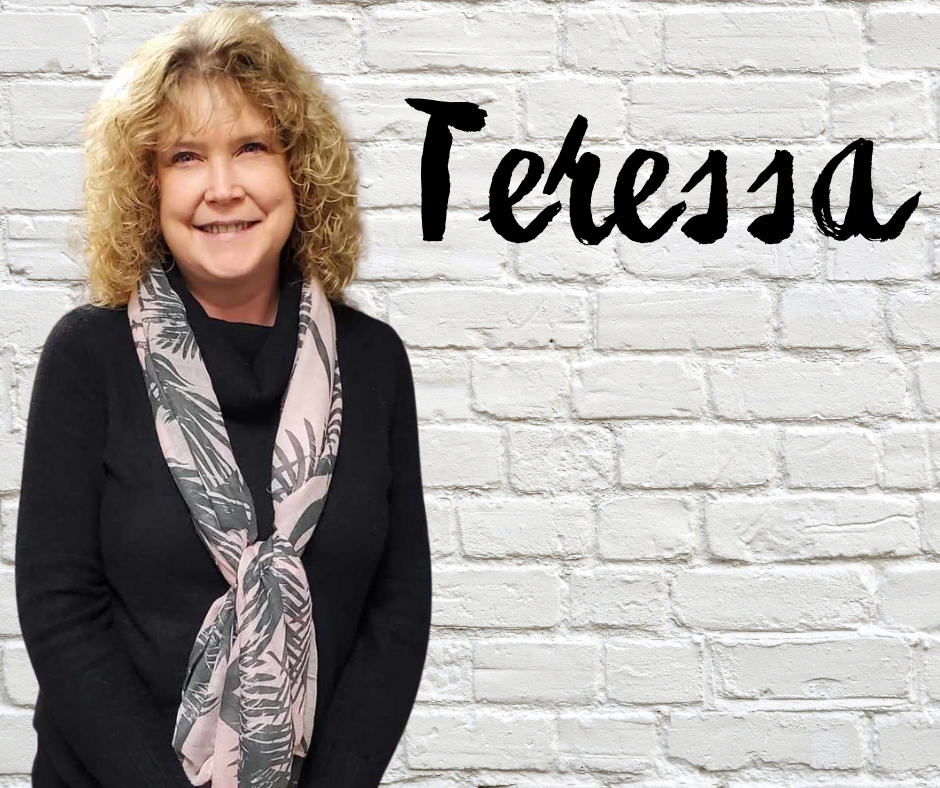 FLIC New York Connects Specialist Teressa Sivers (she, her) Finger Lakes Independence Center New York Connects Specialist Teressa Sivers (she, her) in front of a white brick wall with first name in black letters