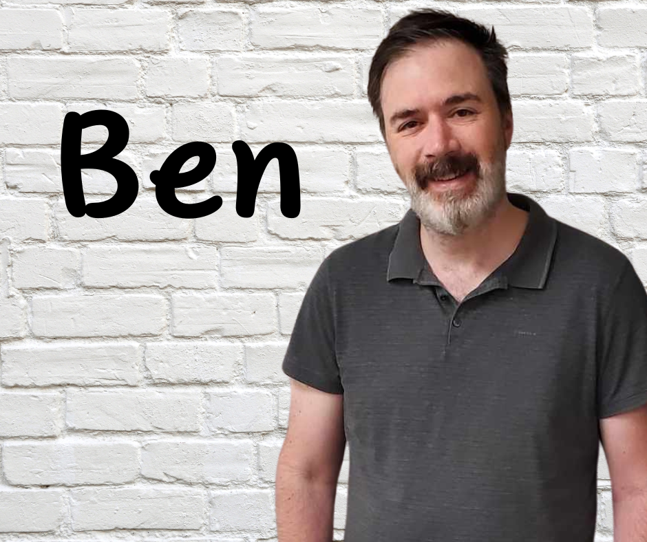 Finger Lakes Independence Center NY Connects Specialist Benjamin Bassett in front of a white brick wall with first name Ben in black letters