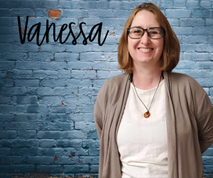 Finger Lakes Independence Center American Dream Employment Network Point of Contact Vanessa Reed in front of a blue brick wall with first name Vanessa in black letters