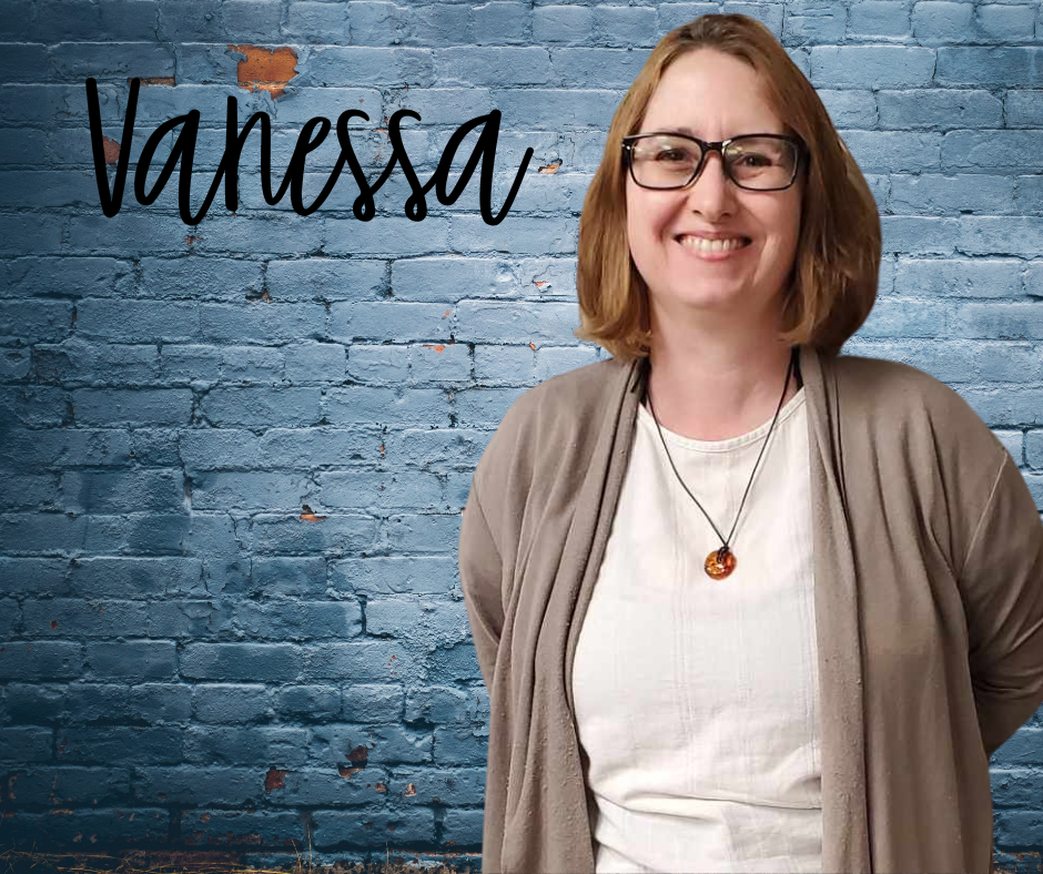 Finger Lakes Independence Center American Dream Employment Network Point of Contact Vanessa Reed in front of a blue brick wall with first name Vanessa in black letters